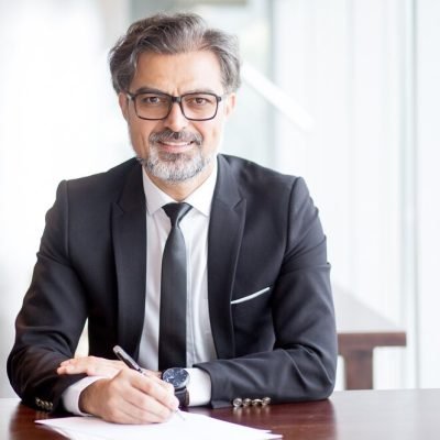 smiling-handsome-business-leader-making-notes_1262-5654